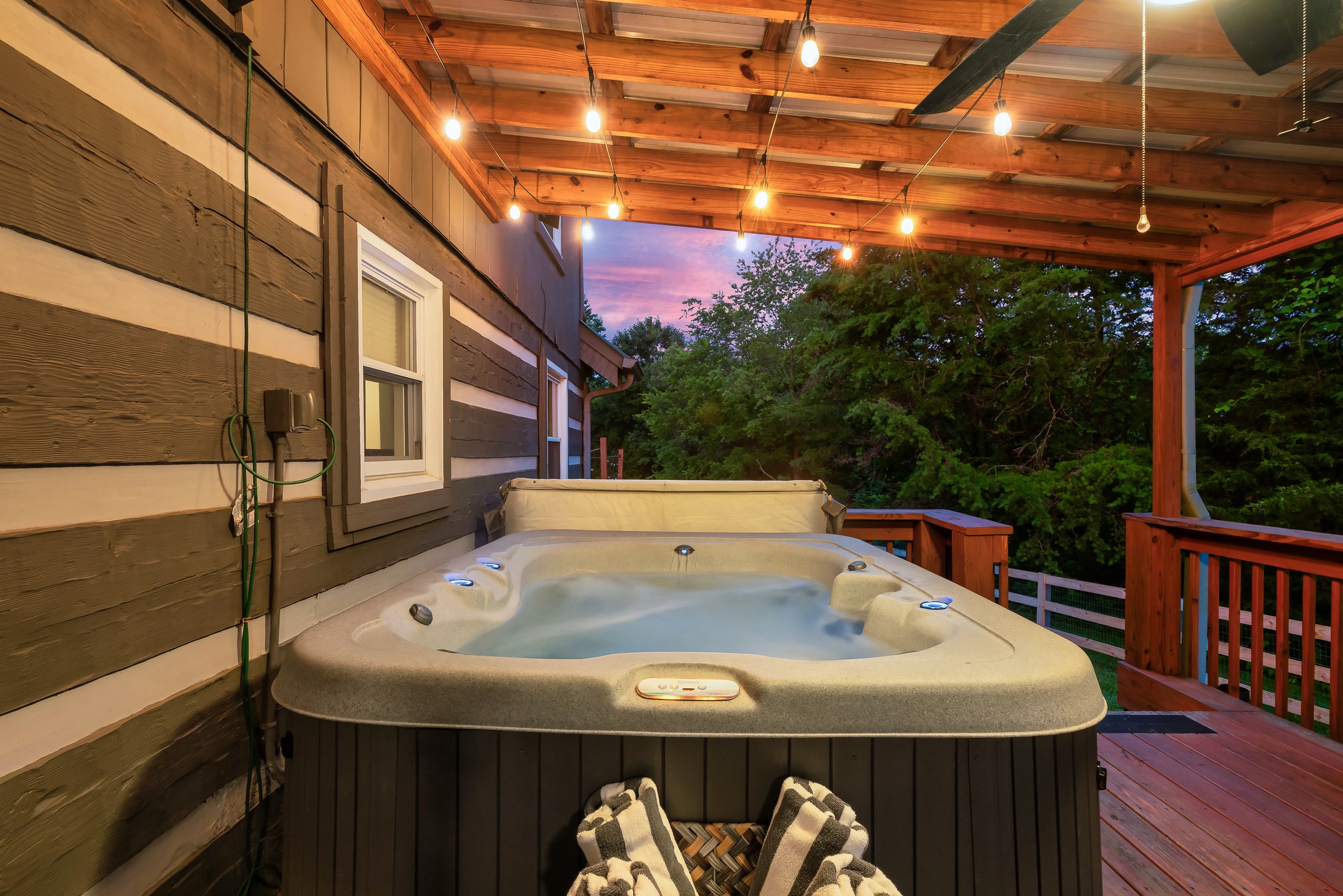 Hillside Haven hot tub on covered deck with forest views in Tennessee mountains