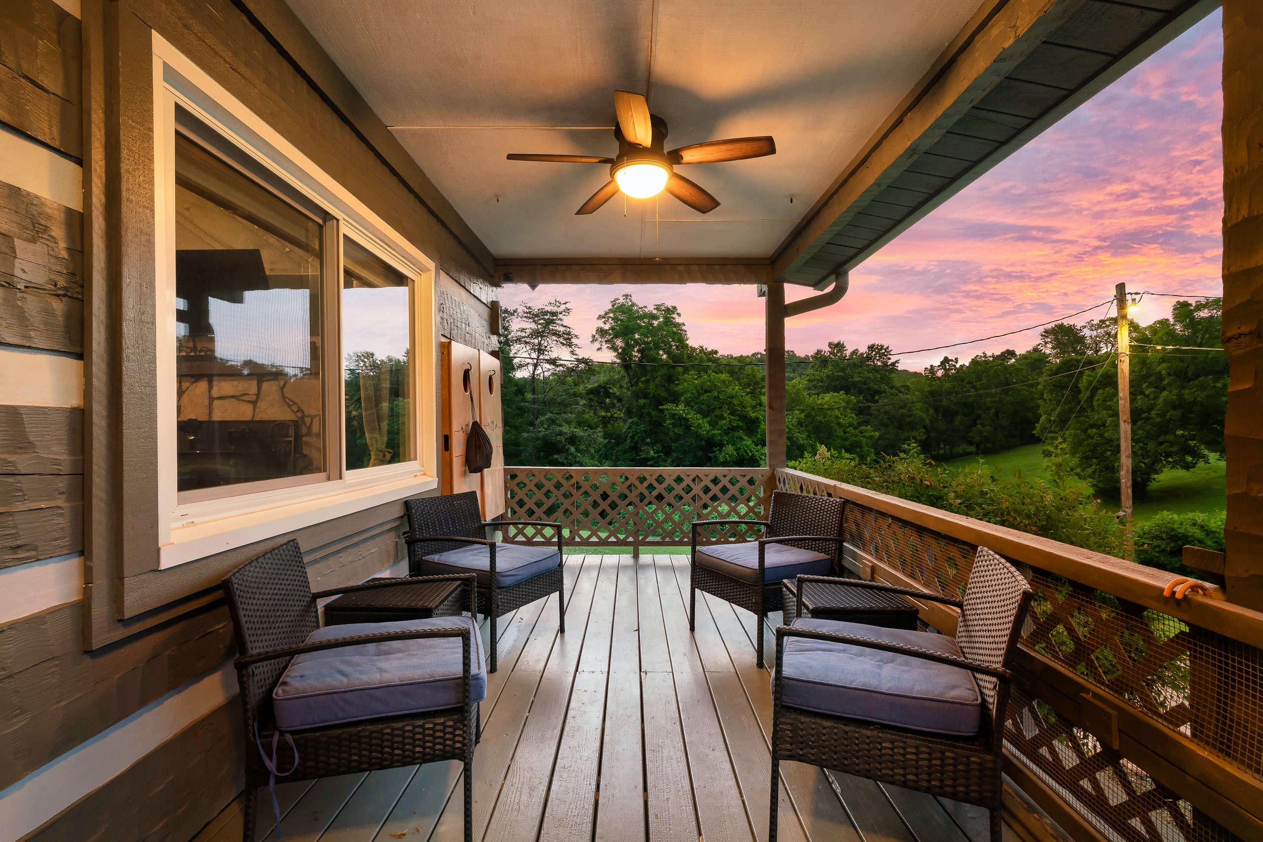Hillside Haven covered front porch with wicker chairs at sunset in Tennessee