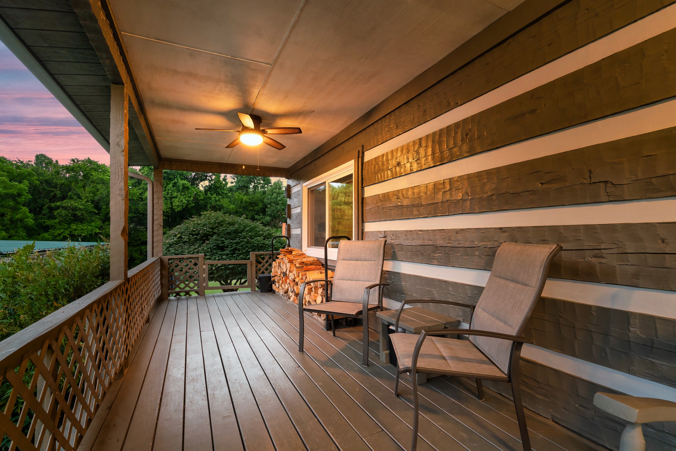 Hillside Haven front porch side view with lounge chairs at sunset in Tennessee