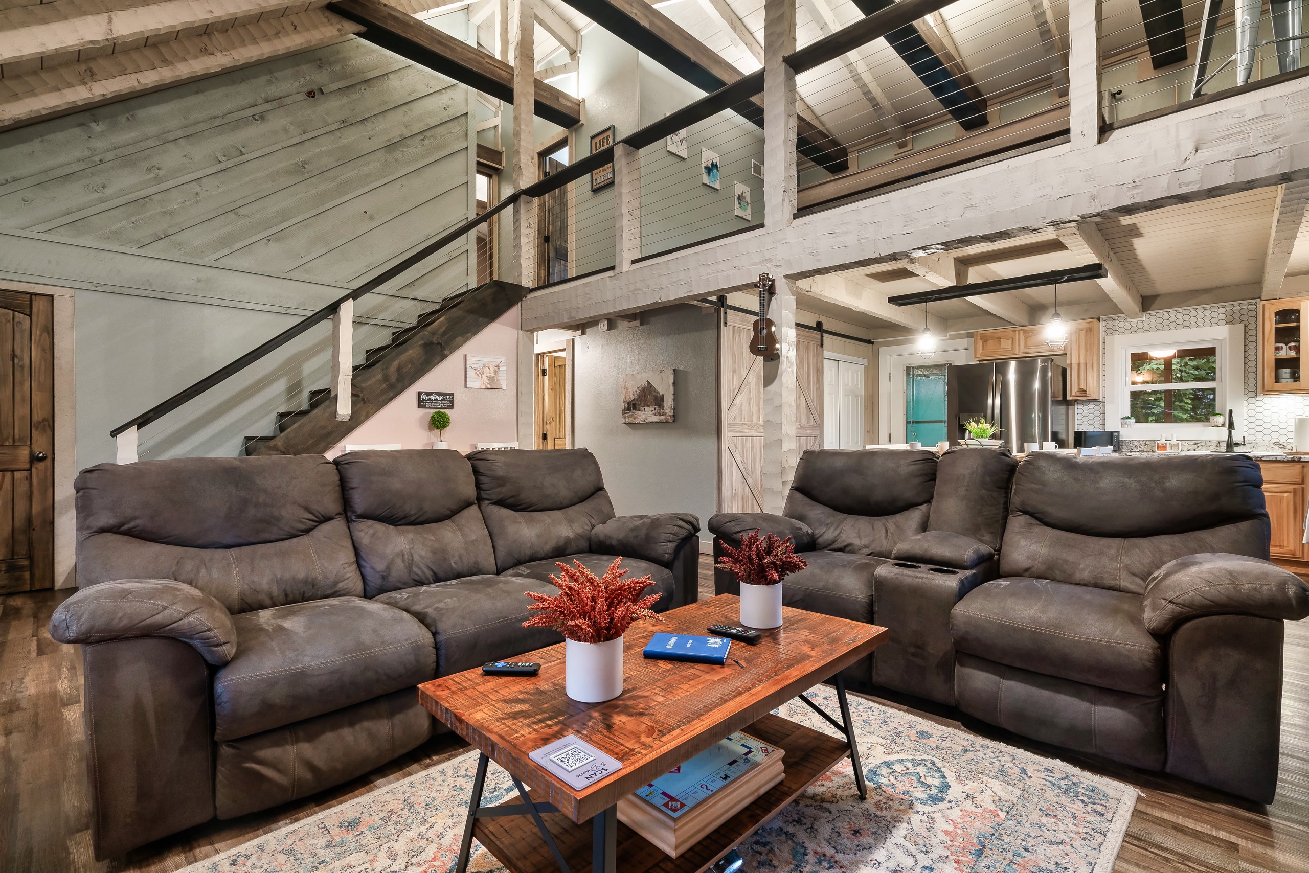 Hillside Haven living room with loft area and barn door kitchen in Tennessee