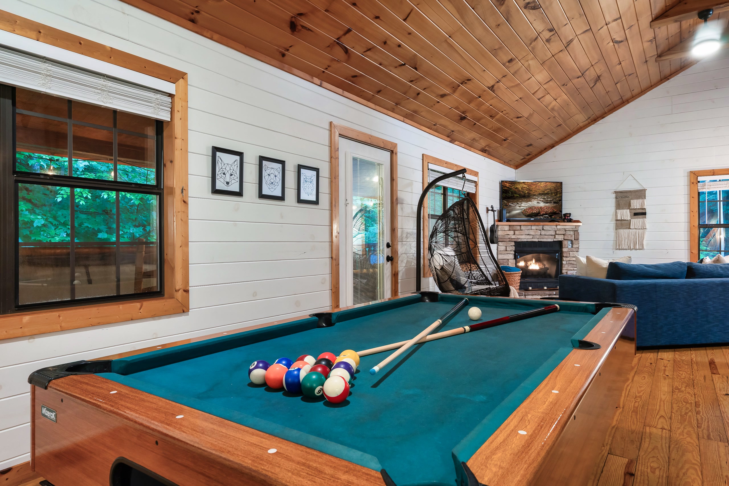 Tennessee cabin game room with pool table and view to living room fireplace