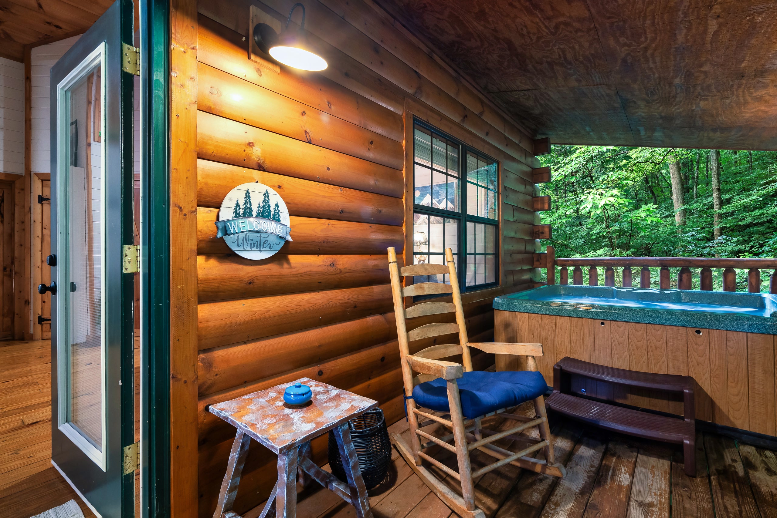 Smoky Creek Hideaway deck with rocking chair, hot tub, and mountain views