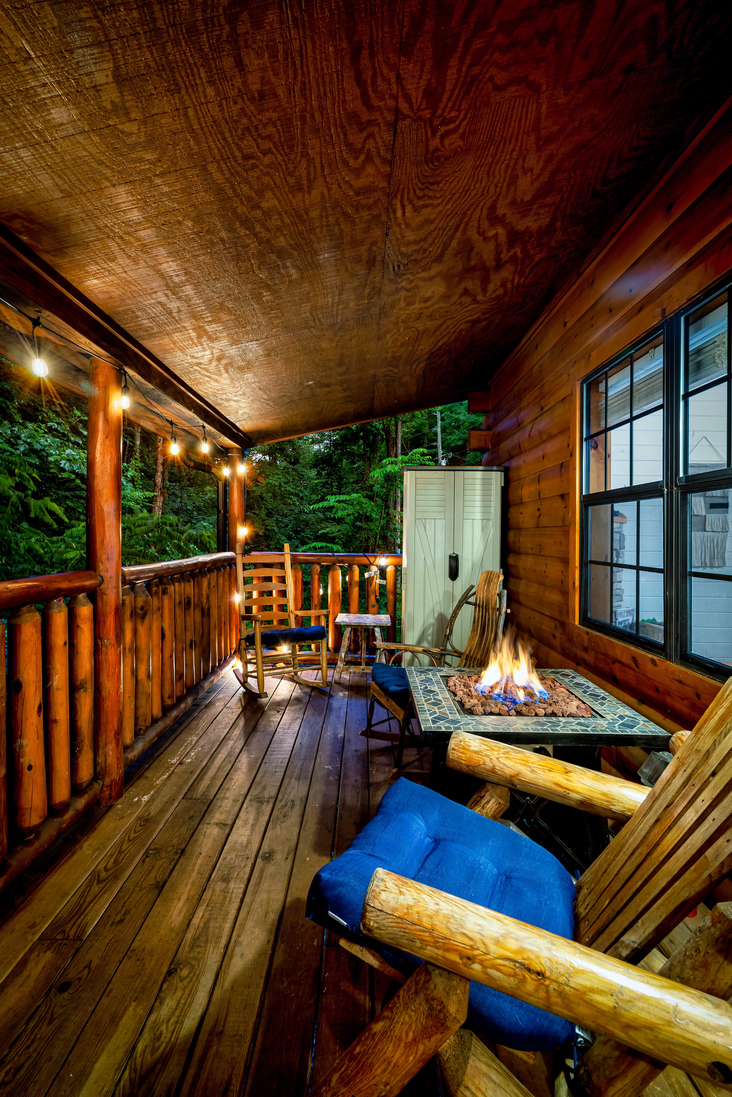 Fire pit on covered deck at Smoky Creek Hideaway Tennessee at evening