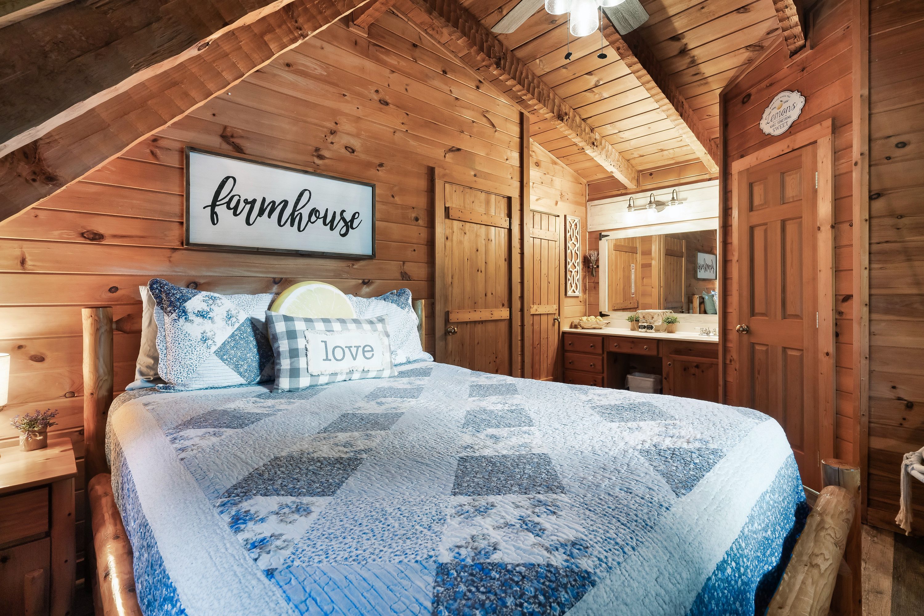 Farmhouse bedroom with patchwork quilt at Rustic Rooster cabin