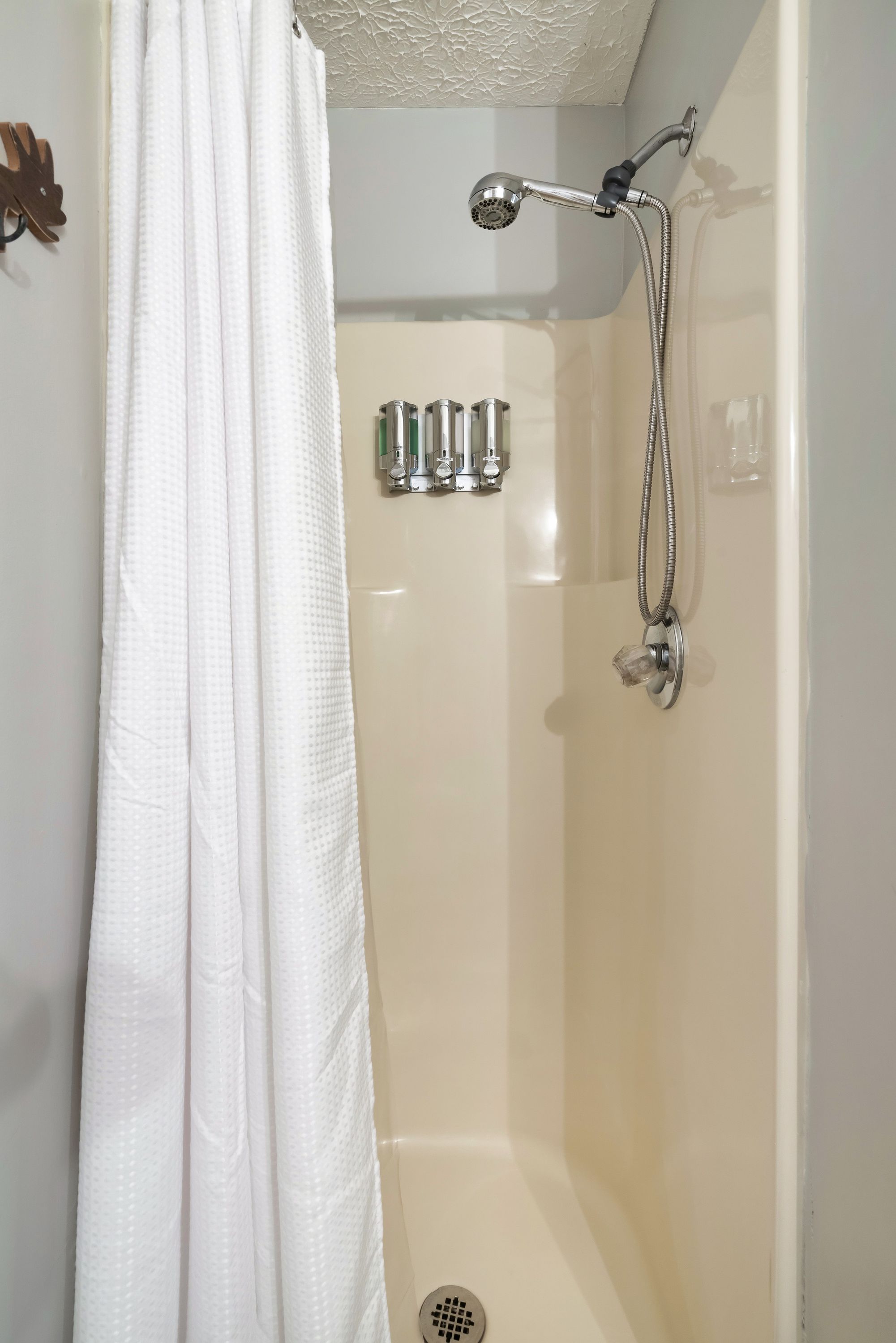 Shower stall with handheld showerhead at Rustic Rooster bathroom