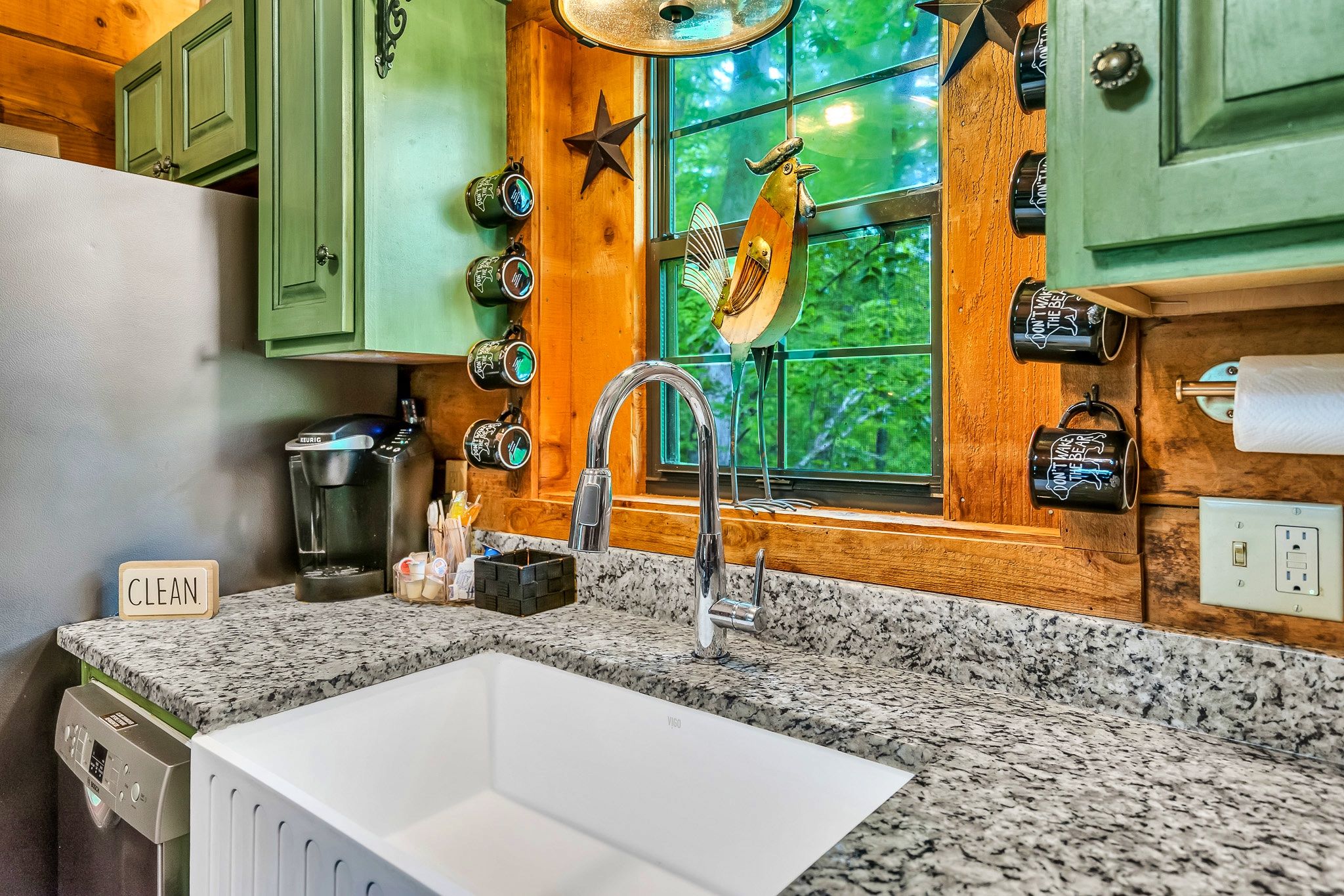Farmhouse kitchen sink with rooster decor at Rustic Rooster cabin