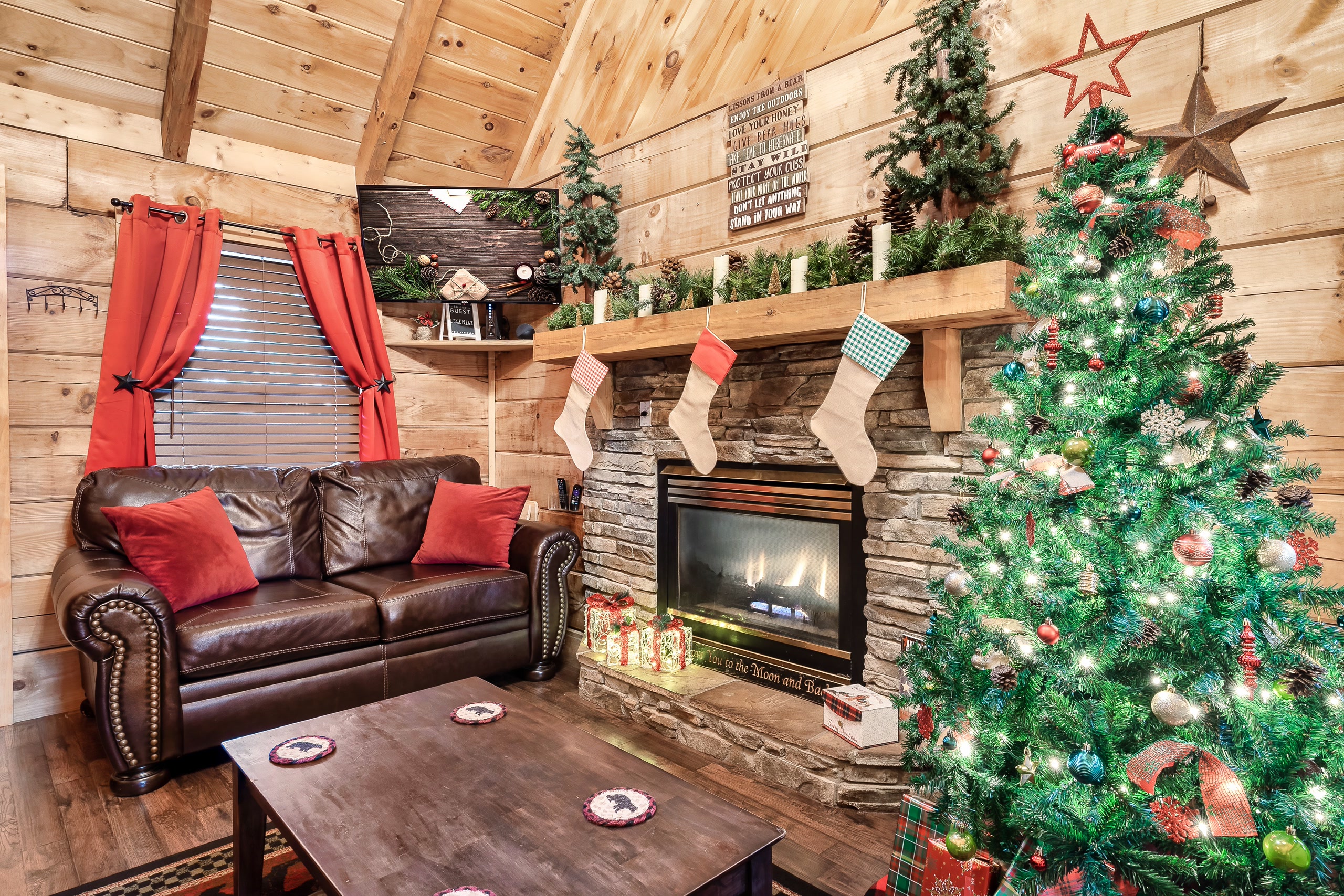 Christmas decorated living room at Rustic Rooster cabin with tree and fireplace