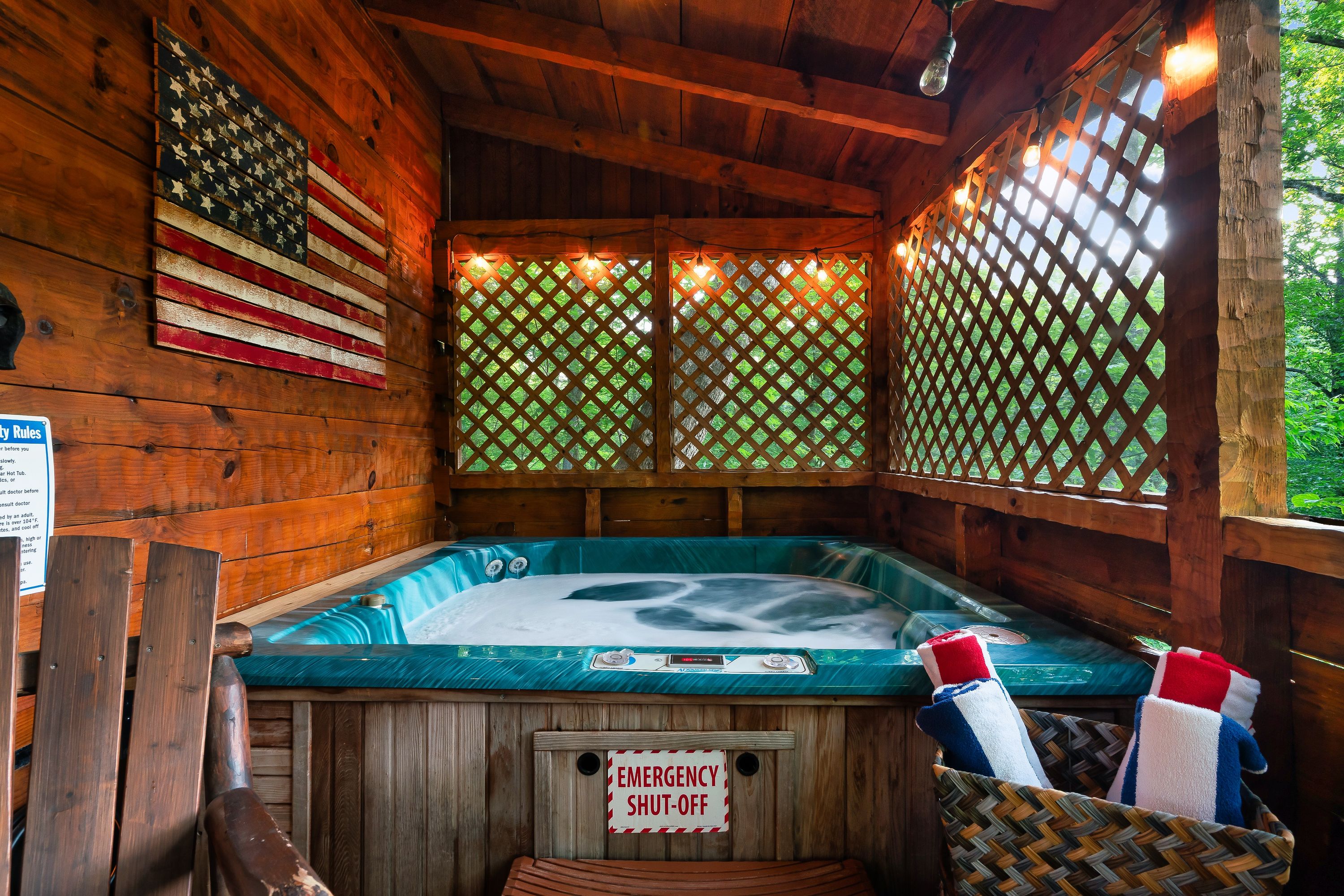 Hot tub on covered deck at Rustic Rooster with lattice privacy screens