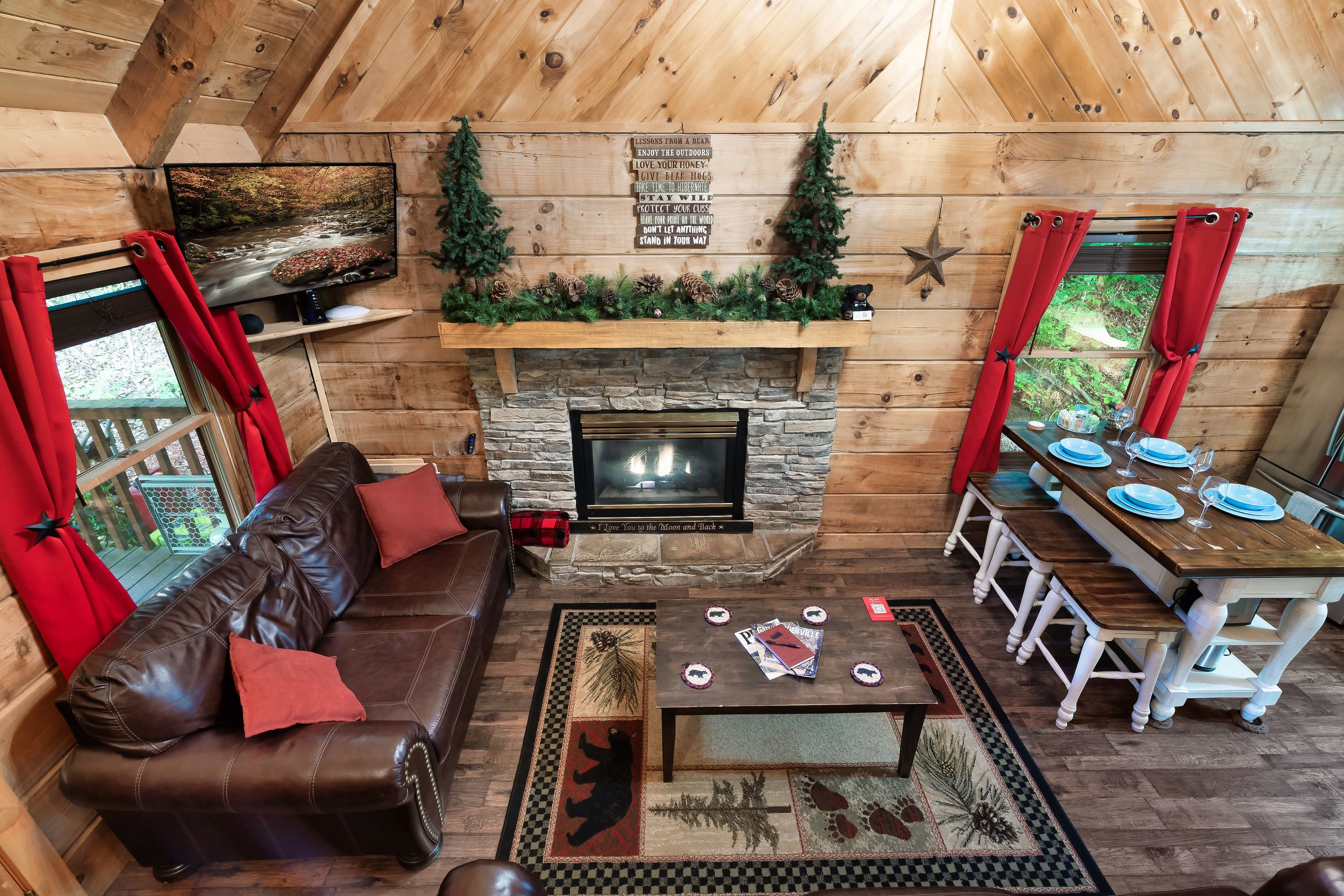 Rustic Rooster living room with leather sofas and stone fireplace